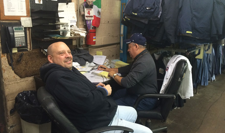 In West New York, NJ Group Of People Sitting Working In Their Industrial Workwear Image - Prime Uniform Supply